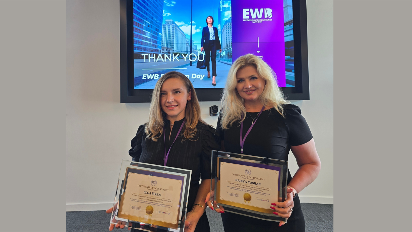 Two members with certificates of achievement